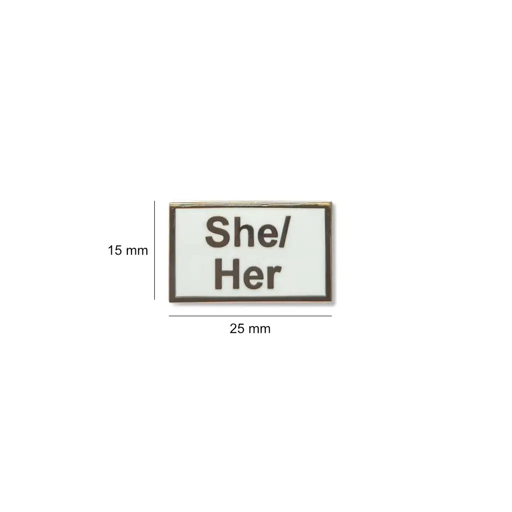 White She/Her lapel pin with black text, shown with measurements of 25mm wide by 15mm tall compact, polished, and perfect for visibility on clothing or bags.