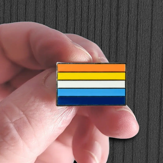 Hand holding a small rectangular object with horizontal stripes on a dark background