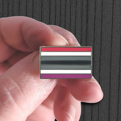 Hand holding a flag with horizontal stripes on a dark background