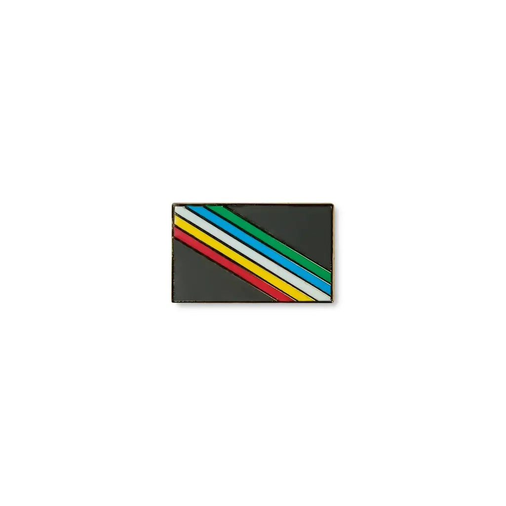 Disability lapel pin with a black background and five diagonal stripes in red, yellow, white, blue, and green, symbolising disability pride, diversity.