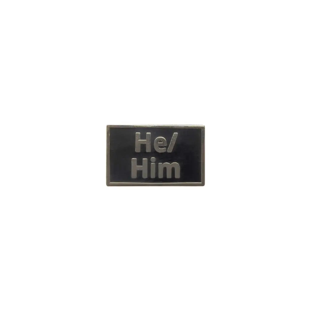 Black He/Him lapel pin featuring embossed metallic text, offering a sleek, professional design for subtle pronoun visibility and gender identity expression.