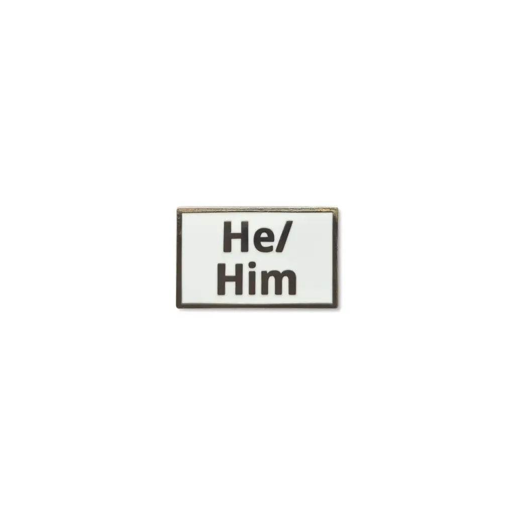 Rectangular He/Him lapel pin with a clean white enamel background and bold black lettering, framed with a thin metallic border a clear and simple pronoun badge ideal for everyday wear.