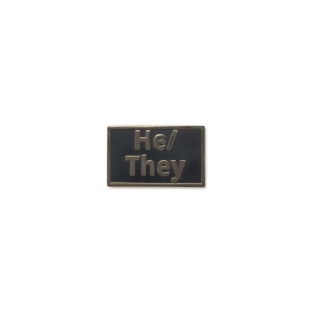 Black He/Him lapel pin featuring embossed metallic text, offering a sleek, professional design for subtle pronoun visibility and gender identity expression.