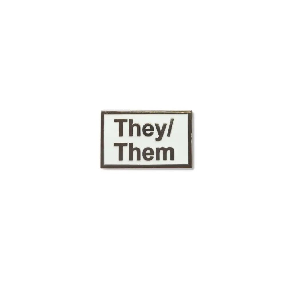 Rectangular They/Them lapel pin with bold silver lettering on a glossy black enamel background, symbolizing nonbinary pronoun visibility and gender identity pride