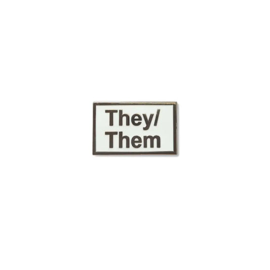 Rectangular They/Them lapel pin with bold silver lettering on a glossy black enamel background, symbolizing nonbinary pronoun visibility and gender identity pride