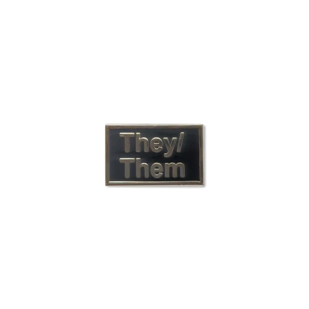 Minimalist They Them lapel pin with dark lettering on a clean white enamel background, designed to highlight nonbinary pronouns in a subtle and stylish way
